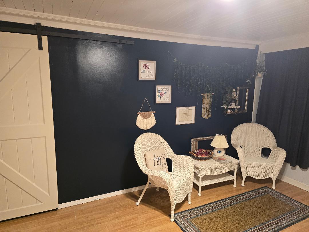 Waiting room with two white wicker chairs